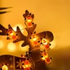 Kép 10/10 - 30 LED-es karácsonyi dekoratív függőlámpa, meleg fehér tündérfüzér, elemes (300 cm) - Csengő formákkal